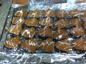 Line up some cookies on a cooling rack. A sheet of foil or waxed paper under the rack will make clean up easier. Sqiggle and drizzle the icing onto the cookies. There is no wrong way to do it. The uneven lines are part of the fun.