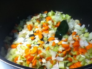Aromatics, assemble! I use all of them- onion, garlic, celery, carrots, and a big old bay leaf. Sweat it all down with just a little sprinkle of salt, it takes about 15 minutes or so.